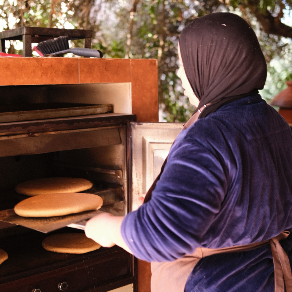 woman putting bread in the oven