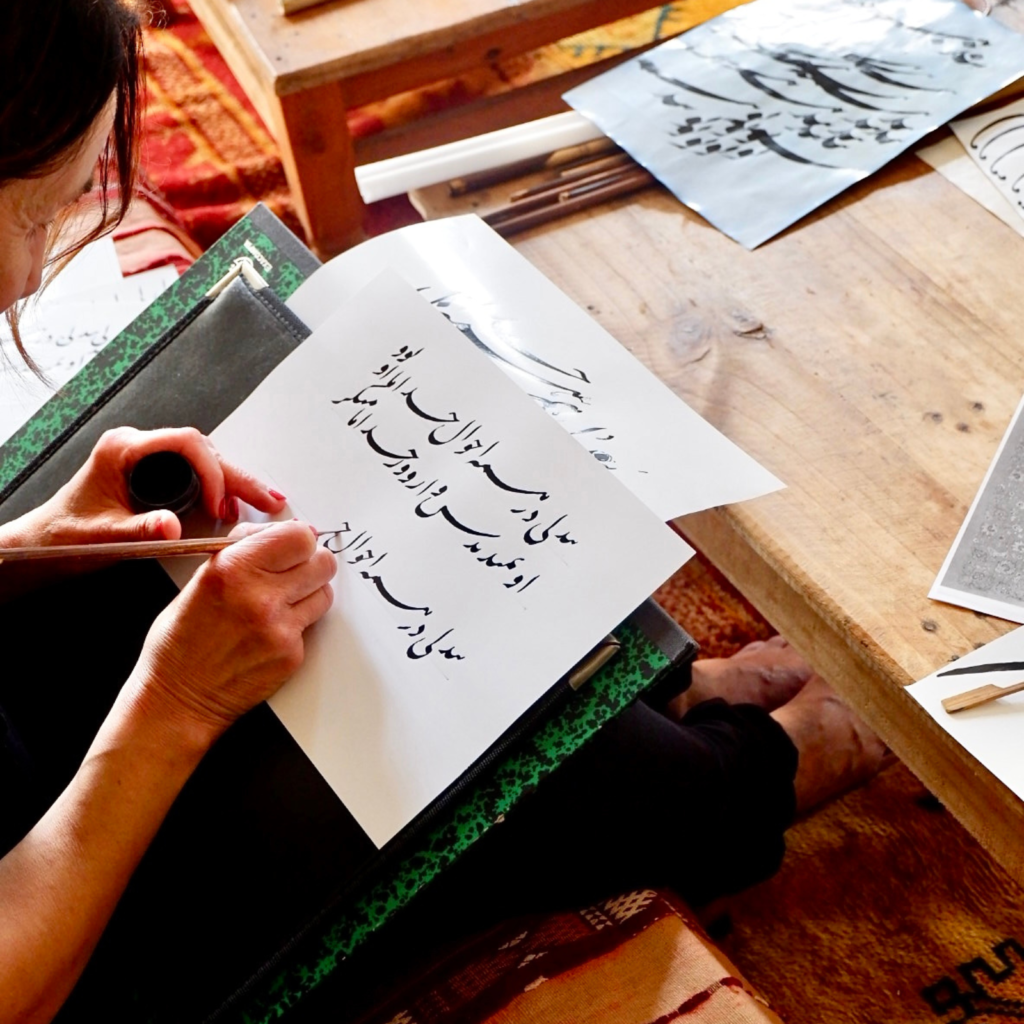 woman writing in arabic caligraphy