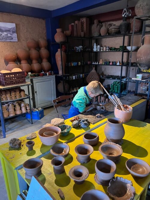 child playing with clay in a pottery workshop