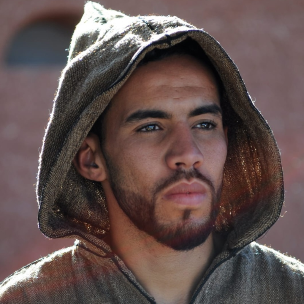 man with beard and hood in moroccan traditional vest