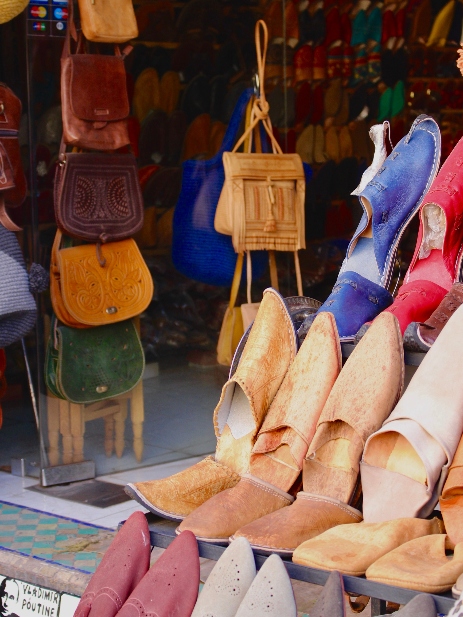 colorful leather shoes and bags in souk open-air market