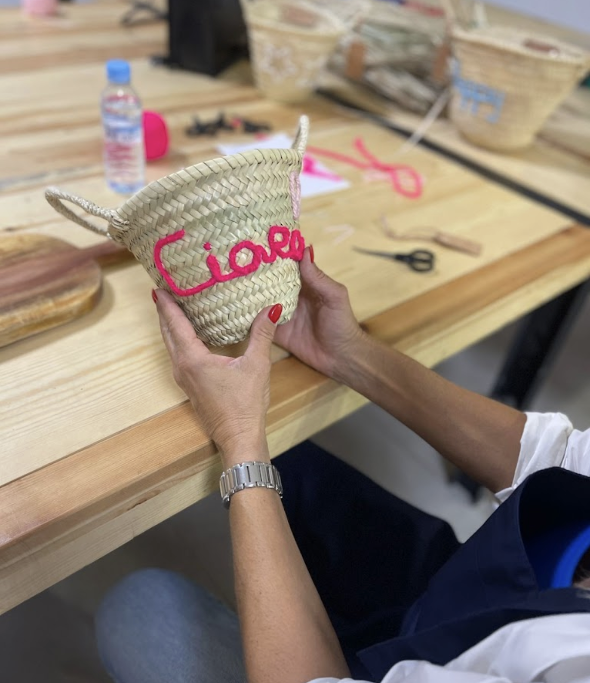 a embroidered basket behind held